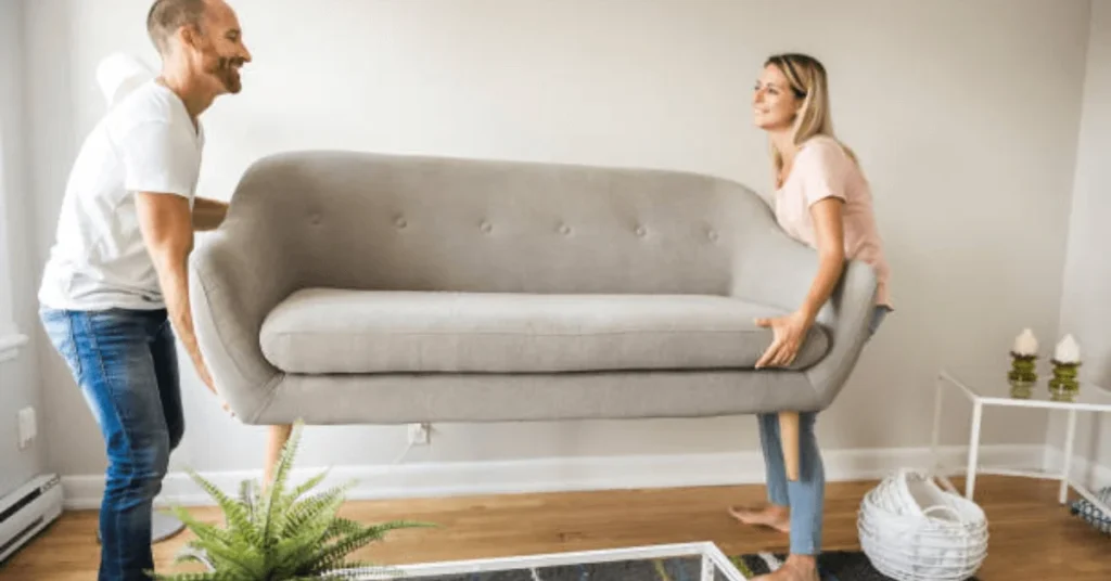 Couple moving sofa