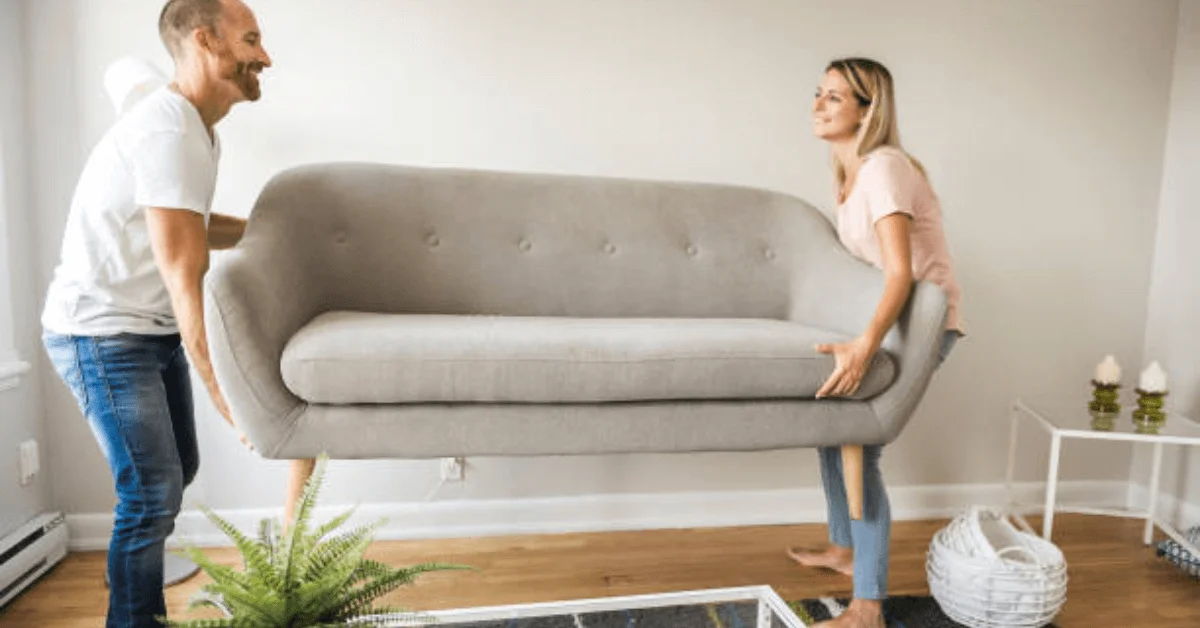 Couple moving sofa