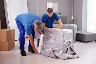 professional packing team carefully wrapping and packing items